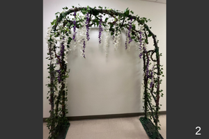Decorative arch with vines and purple and white hanging flowers