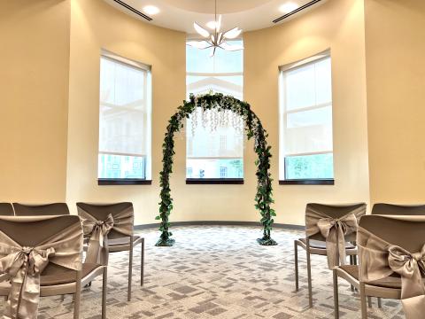 Wedding setup in Community Room 308/309 with arch and flowers